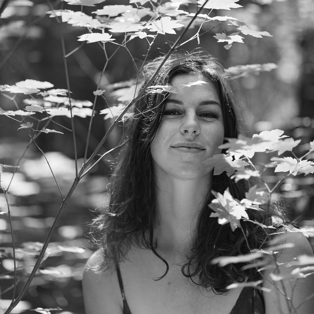Person sitting in the woods - black and white photograph.